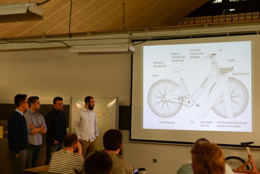Mike Witzmann, Joe Craig-Ferraz, Geoff Declouet and Kenny Nguyen present their CyShare biking system for Iowa State on March 28 in the industrial design student space of the Armory.