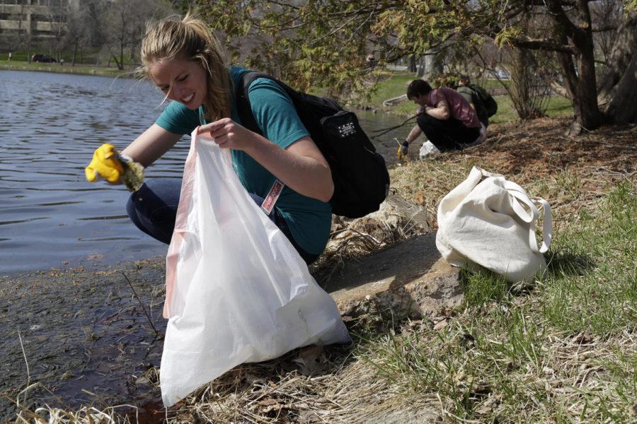 Alex Gustafson, senior in environmental science, along with other students clean up trash out of Lake LaVerne as part of the campus clean up event organized by The Green Umbrella in April 2014. The Green Umbrella is a sustainability student organization.