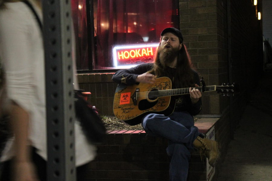 Mark Simpson, 27, is an Ames resident who started performing on Campustown streets 10 months ago. In Ames, college students, bar patrons and even police officers take notice of the frequent number of musicians who appear on the streets during the weekend.