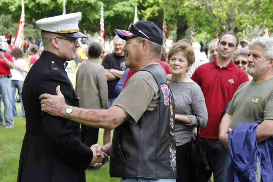 Capt. Jake Dobberke, a retired U.S. Marine who grew up in Ames, greets community members after the Memorial Day ceremony on May 26, 2014.