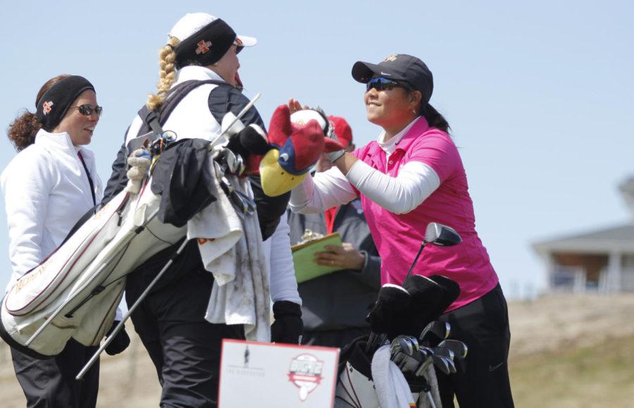 Iowa States Chonlada Chayanun gets a congratulatory high five from teammate Cajsa Persson in the second day of the 2013 Big 12 Womens Golf Championship at the Harvester on April 20, 2013, in Rhodes, Iowa.