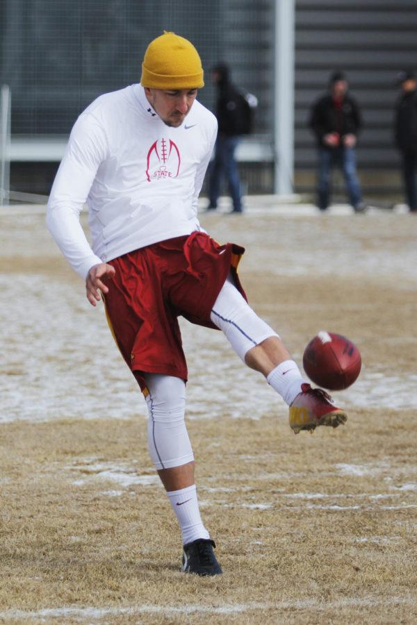 Senior punter Kirby Van Der Kamp punts the ball for NFL scouts during 2014 Pro Day on March 25 at the Bergstrom Football Complex.