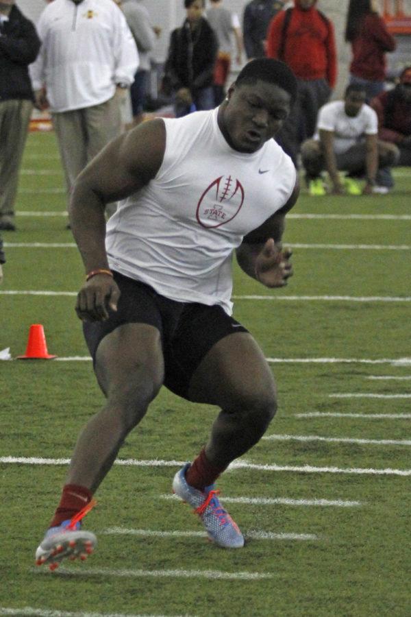 Senior linebacker Jeremiah George runs drills during 2014 Pro Day on March 25 in the Bergstrom Football Complex.