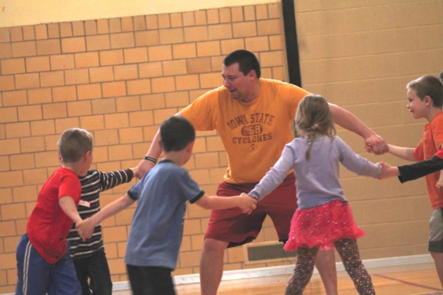 Matt+Meintsma%2C+senior+in+elementary+education%2C+leads+a+group+of+young+students+in+exercises+as+part+of+a+physical+education+program+for+home-schooled+youth+in+Ames.+The+program+educates+children+basic+skills+they+would+receive+in+a+traditional+physical+education+program+while+providing+ISU+students+a+platform+to+present+the+skills+they+gained+from+the+classroom.