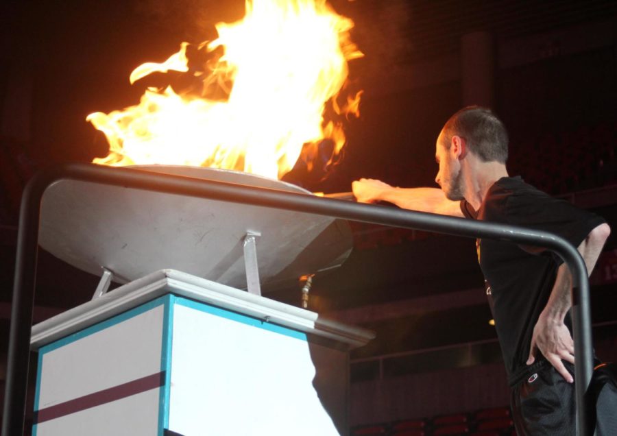 Stephen Grayum, a local Ames athlete, lights the torch at the opening ceremonies in Hilton Coliseum on May 22.