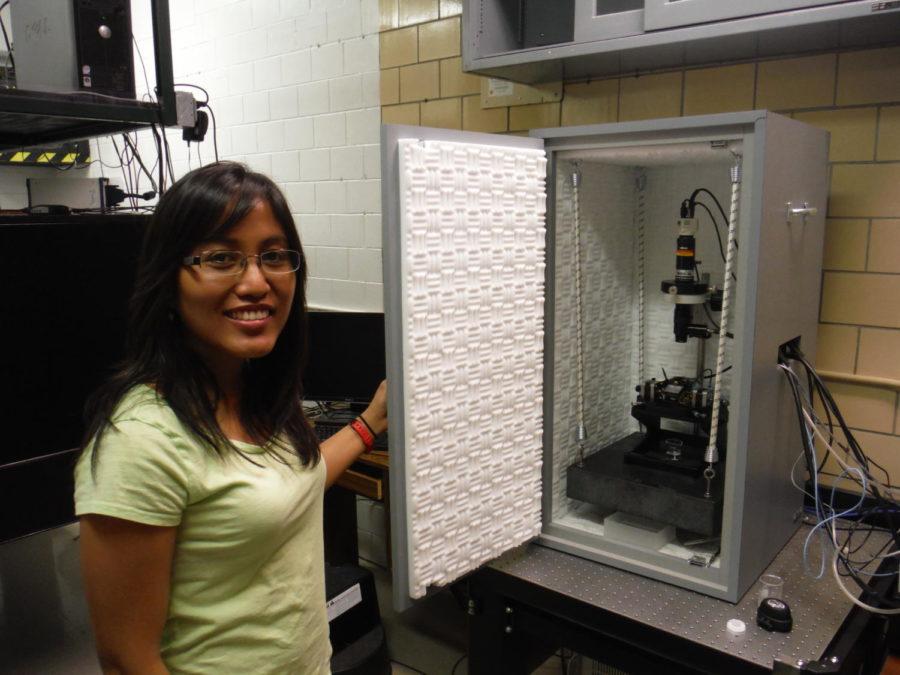 Co-Author Kristine Manibog poses with the atomic force microscope used in the research of catch bonds.