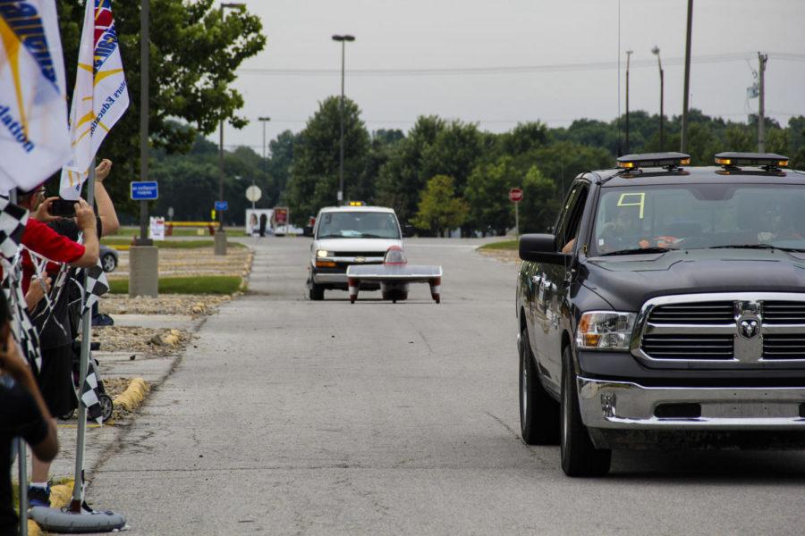 The Iowa State Team PrISUm solar car Phaeton arrives at the American Solar Challenge checkpoint in the Hilton Coliseum parking lot on July 26.