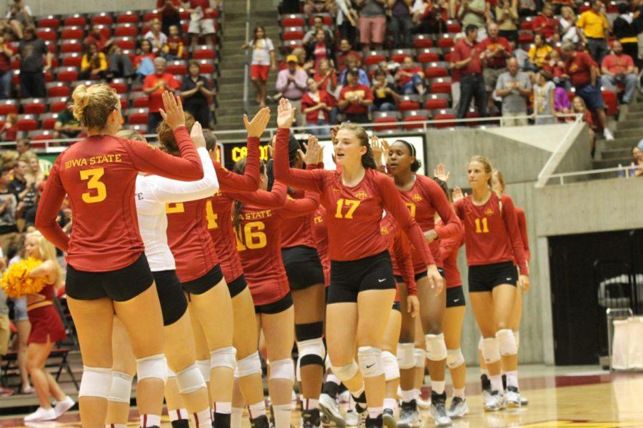 The ISU volleyball team exchanges high-fives before the match against Stanford on Aug. 29.