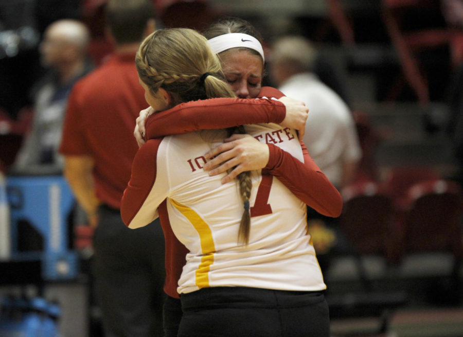 Sophomore defensive specialist Caitlin Nolan consoles senior libero Kristen Hahn on Hahns last home game at Iowa State against Texas on Nov. 27, 2013, at Hilton Coliseum. The Cyclones lost the match 25-27, 25-17, 13-25, 16-25.