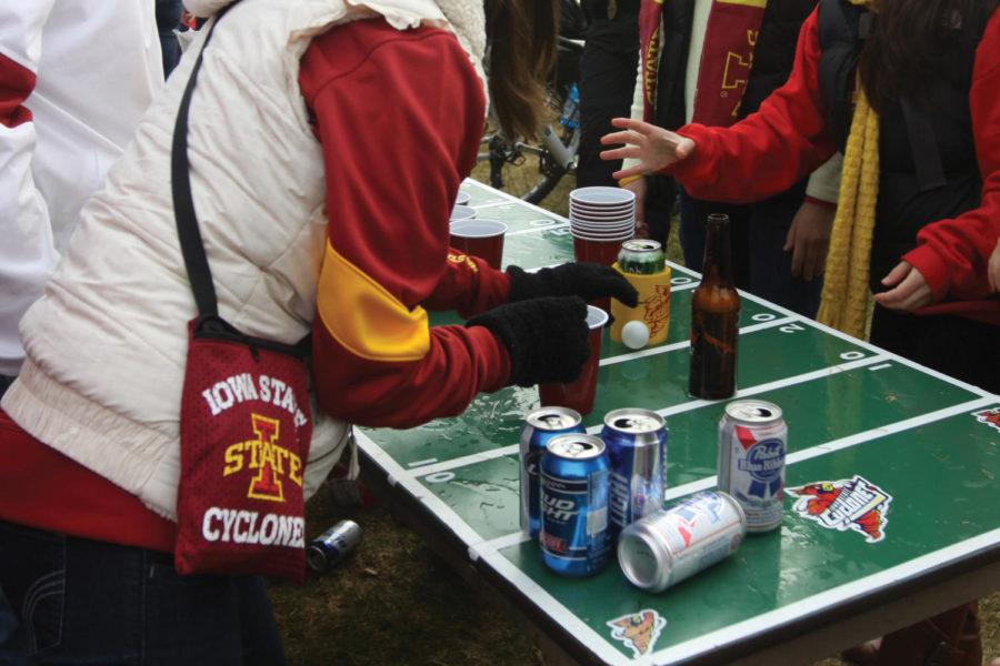 ISU students play a drinking game while tailgating. Though a football game is a great time to socialize with friends, be cautious with how much alcohol is consumed, especially if you are under the age of 21.