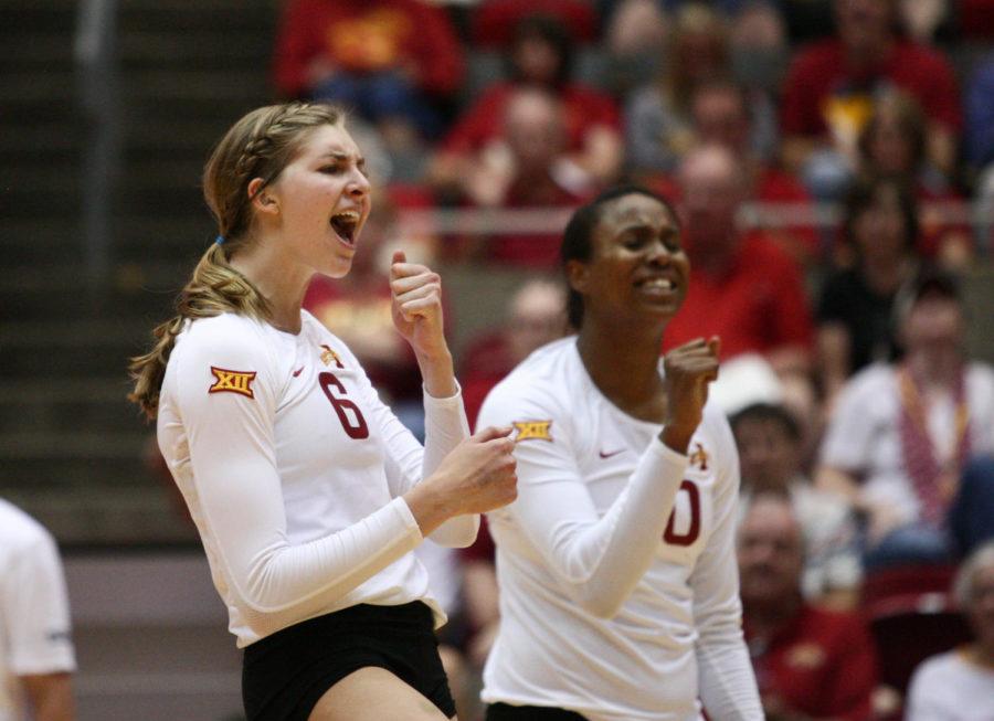 Freshman Alexis Conaway and senior Victoria Hurtt celebrate after winning a point against the University of Iowa on Sept. 20. The Cyclones swept the Hawkeyes in three sets. 