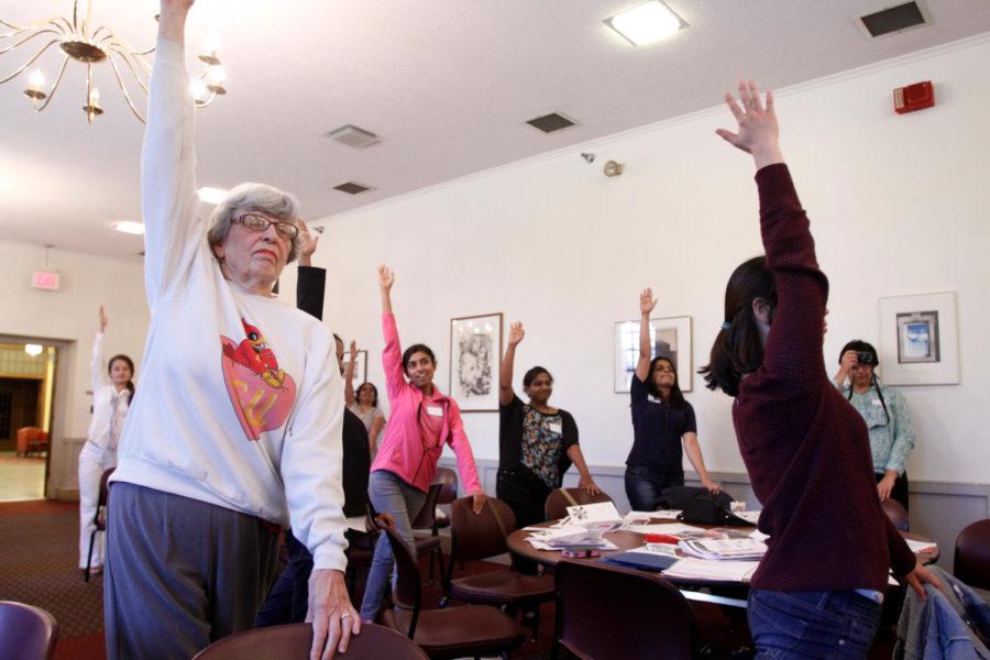 Barbara Gwiasda, far left, stretches with other women in the Engaging International Students meeting Sept. 16. The meeting, which took place in the Cardinal Room of the Memorial Union, focused on introducing international spouses to Recreational Services, CyRide and other services that are provided in the Ames community.