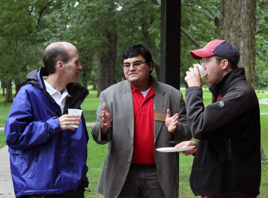 Arko Provo Mukherjee, center, president of Graduate and Professional Student Senate, talks with Bill Graves, left, associate dean of the Graduate College and GPSS adviser, and TJ Rakitan, a fellow student and club member, on Sept. 5.
