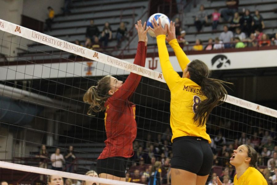 Sophomore setter Suzanne Horner fights for the ball over the net with one of the Minnesota players. Horner had a great performance with seven digs in the 16-25, 20-25, 25-20, 23-25 loss on Sep. 13.
