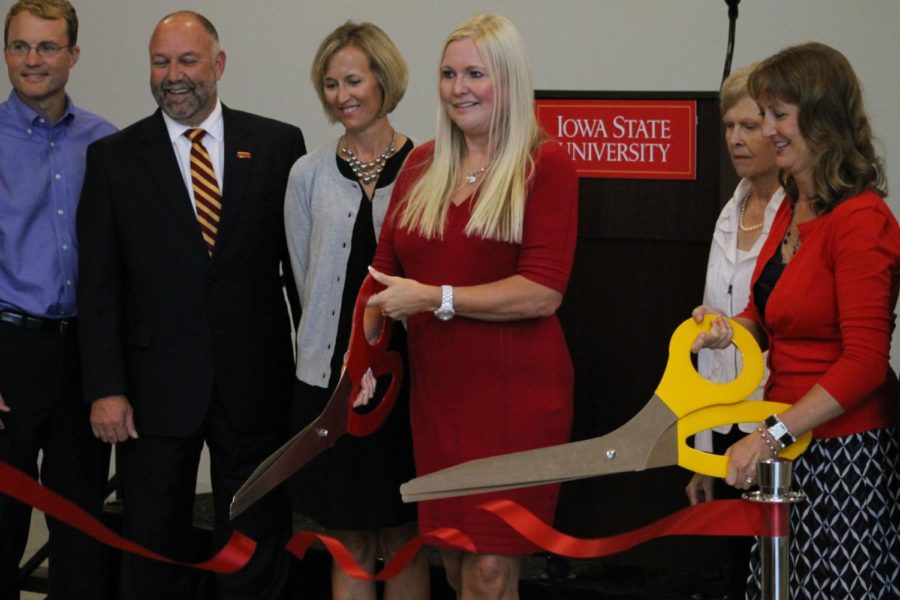 Deb Hansen uses big scissors to cut the ribbon and introduce the new agriculture building. The new building, named after Jeff and Deb Hansen, was officially dedicated Aug. 29.