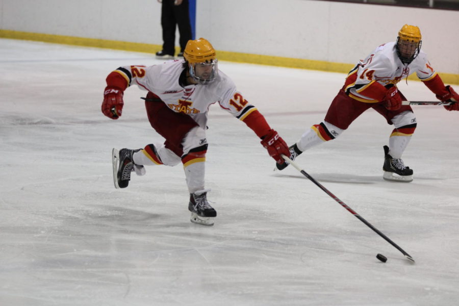 Junior Preston Blanek stretches to regain possession of the puck against the North Iowa Bulls on Sept. 12 at the Ames/ISU Ice Arena.