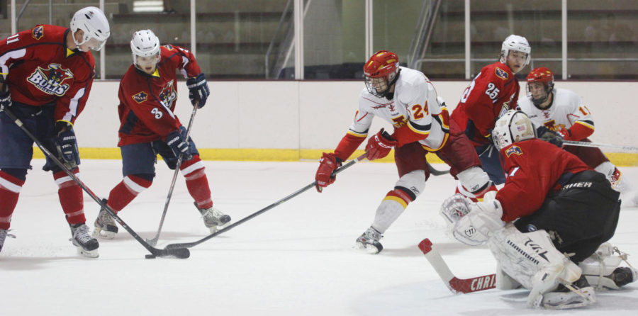 Sophomore forward Austin Parle attempts to snatch the puck close to the goal against North Iowa on Sept. 27 at Ames/ISU Ice Arena. The Cyclones were too much for the Bulls to handle winning 4-2.