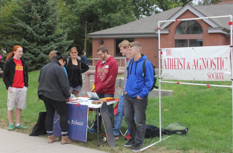 Monica Diaz talks to members of the atheist and agnostic society on thursday Sept. 11 at there weekly ask an atheist booth located in the free speach zone in front of the library. Christjahn Beck, vice president of the society said they are there to get rid of the stigmatizm atheist have and to put a face to it. The club has been on campus for 15 years. The ask an atheist booth started in '09. Once it gets cold the booth will move to the MU.