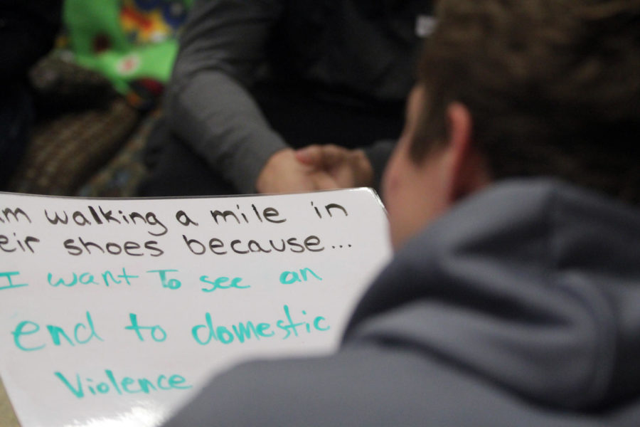 Students wrote why they walk a mile for domestic violence victims at the A Walk in Their Shoes event on Oct. 19 on Central Campus.
