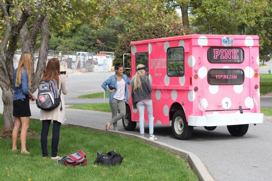 Students pose with the Pink truck at the Pink pop-up store in the driveway of the Kappa Kappa Gamma Sorority on Sept. 23.