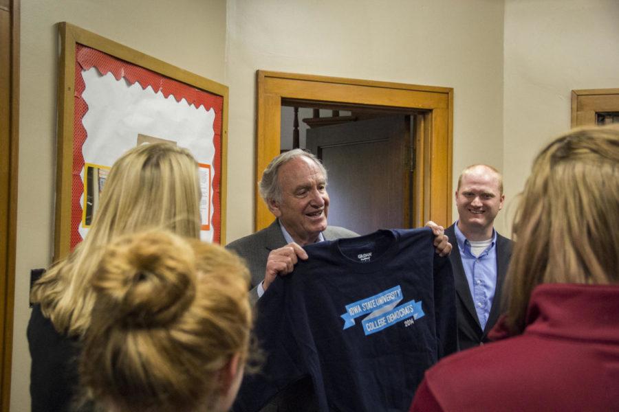 Sen. Tom Harkin holds up an ISU College Democrats sweatshirt given to him at a voting rally on Oct. 14 at the Margaret Sloss Womens Center on campus.