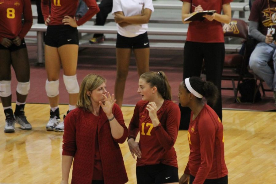 From left, coach Christy Johnson-Lynch, sophomore setter Suzanne Horner and senior outside hitter Victoria Hurtt discuss strategy after a play. The Cyclones lost 16-25, 20-25, 25-20, 23-25 against Minnesota on Sep. 13. 