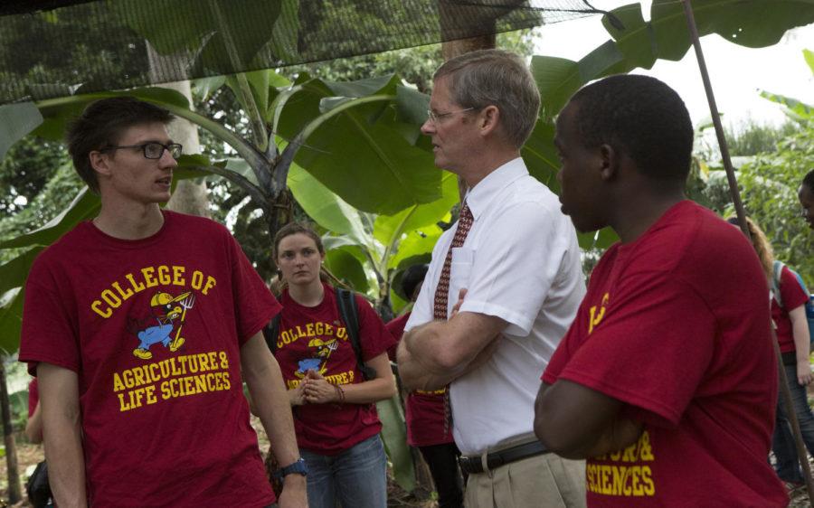 David Acker, Associate Dean of ISU’s academic and global programs, learning about the school garden program from Iowa State and Makerere University students.