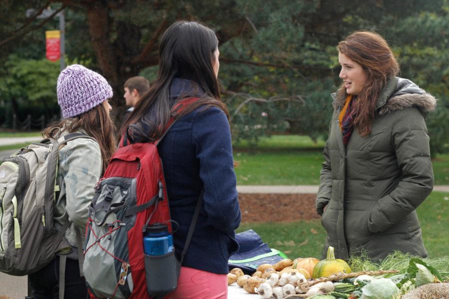 Rebecca Clay, junior in global resource systems, talks to students about organic farming during Sustainability Day in front of Parks Library on Wednesday, Oct. 23. Clay is a member of the ISU Student Organic Farm, a campus club that uses organic farming methods and seeks to increase community awareness and support of local food systems.