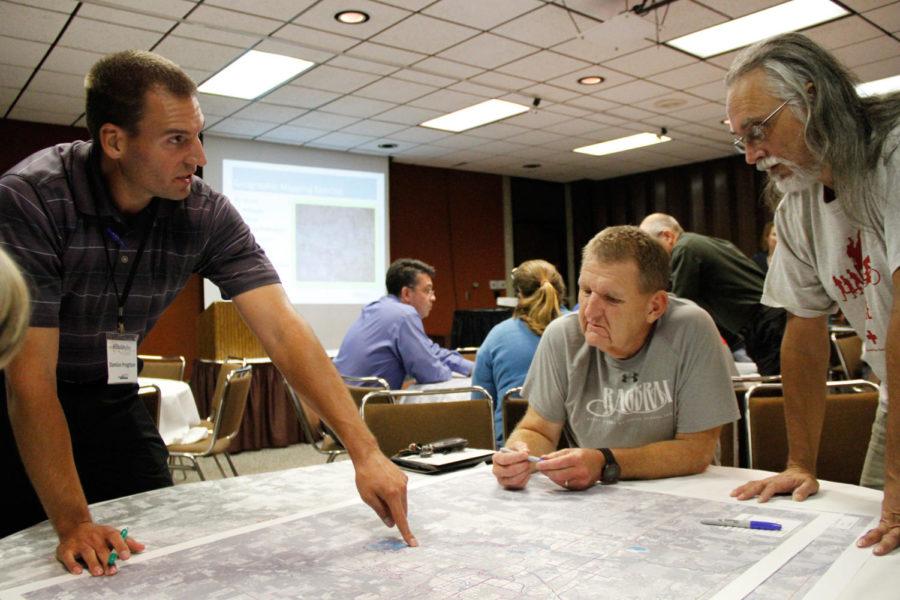 Ames Area Metropolitan Planning Organization Traffic Engineer Damion Pregitzer works with Ames residents Mike Parsons and Jim Wilcox to highlight existing traffic issues with a geographic mapping exercise. The Ames Mobility meeting on Sept. 30 was designed to allow Ames residents to highlight their concerns about existing transportations issues in the Ames area.
