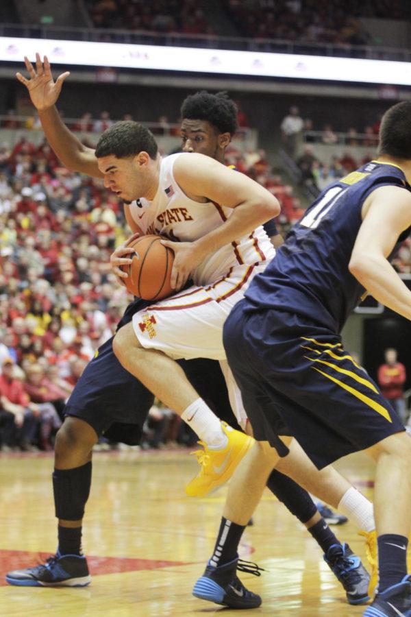 Sophomore Georges Niang fights his way through two West Virginia players on Wednesday, Feb. 26, 2014. Niang had 24 points in 39 minutes for Iowa State. The No. 15 Cyclones defeated the Mountaineers 83-66.
