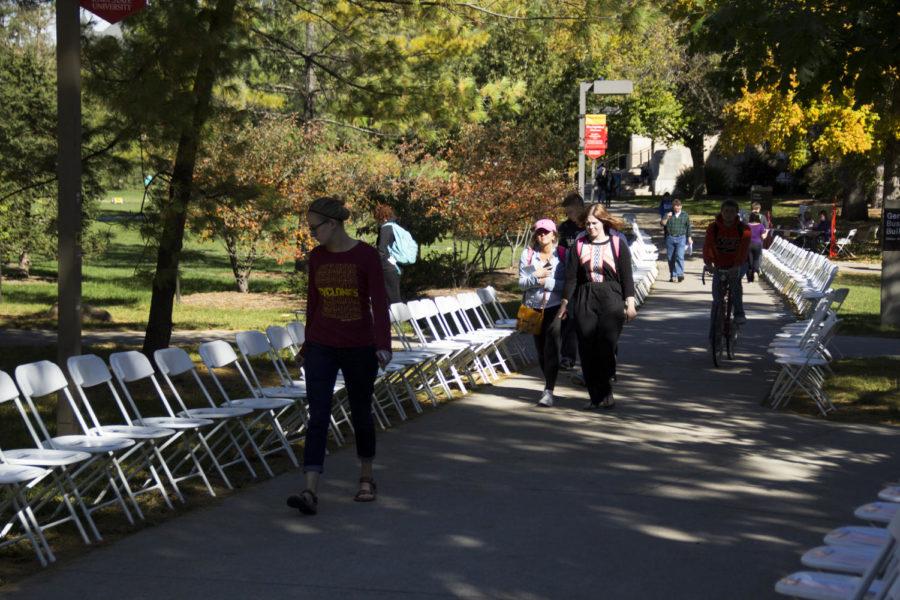 A line of 197 chairs lined the sidewalk leading from the Margaret Sloss House to the Memorial Union on Central Campus on Oct. 16. Each of the 197 chairs represented every man, woman and child in Iowa who has lost his or her life to domestic violence since January 1995.