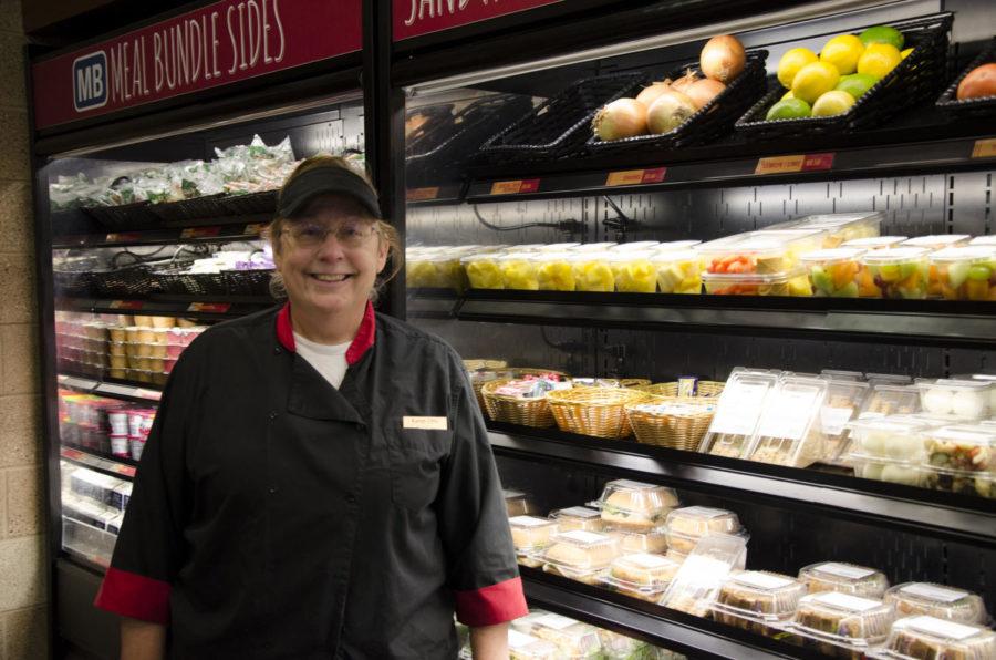 Karen Otto, head cook at Hawthorn Market and Café, stands in front of a display that contains food options that ISU Dining can donate to Food at First in Ames.