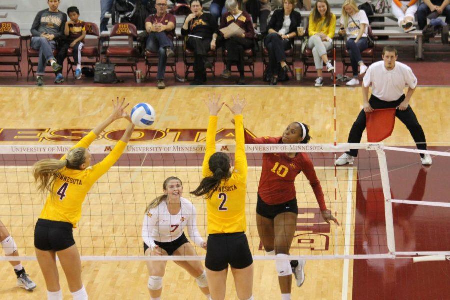 Senior outside hitter Victoria Hurtt spikes the ball through the Minnesota blockers. Hurtt had a strong overall performance in the 16-25, 20-25, 25-20, 23-25 loss. 