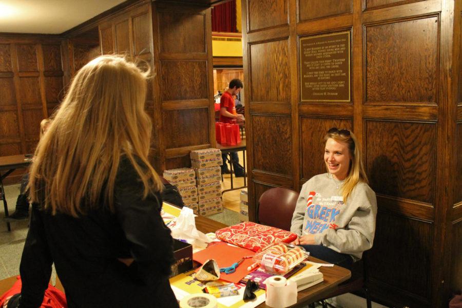Chrissy Jones, senior in psychology and communication studies and member of Sigma Kappa, answers questions at the entrance of the blood drive on March 25. 
