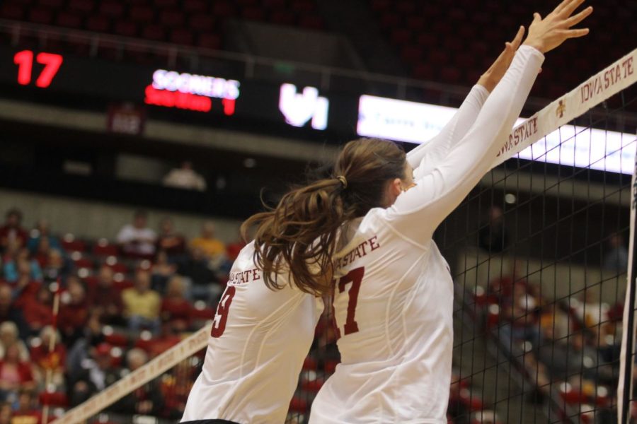 Redshirt freshman middle blocker Samara West, left, and sophomore setter Suzanne Horner work together to block the Oklahoma hitters. West had two blocks and Horner had one block throughout the win on Oct. 12. 