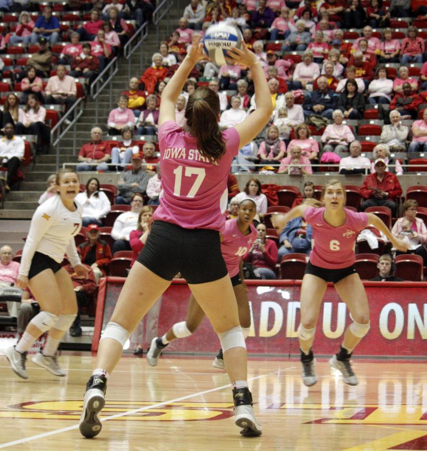Suzanne Horner, left, bumps the ball to Alexis Conaway during the Iowa State volleyball game on Oct. 4 at Hilton Coliseum. The team beat West Virginia 3-1, and they now stand 8-5 overall in the season.