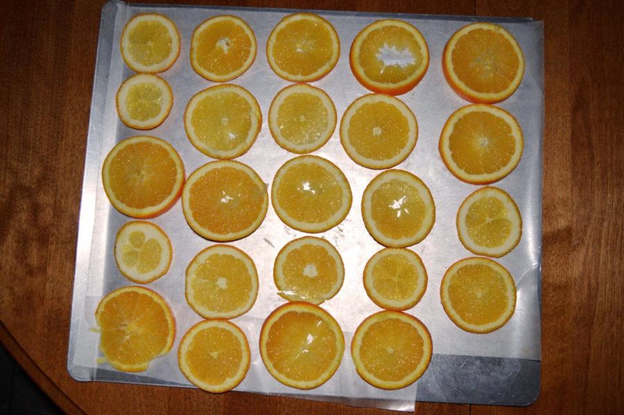 Slice oranges thinly and lay on a baking sheet. 