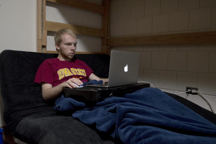 Derek Long, freshman in pre-business, settles into his futon to relax after a day of classes.