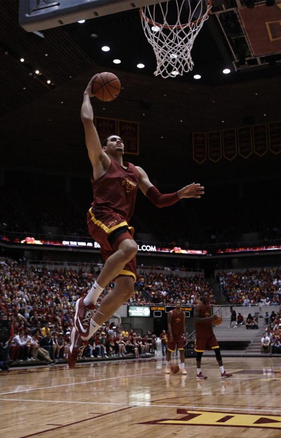 Redshirt junior forward Abdel Nader soars through the air before crushing his first dunk at the Hilton Madness dunk contest. The event, which took place in Hilton Coliseum on Oct. 18, filled the lower level with Cyclone basketball fans.