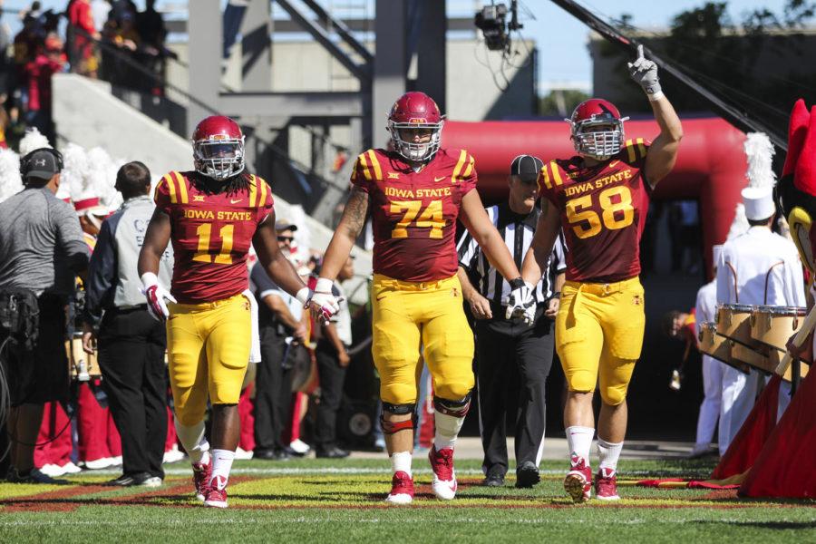 Captains+E.J.+Bibbs%2C+Tom+Farniok+and+Cory+Morrissey+walk+onto+the+field+before+the+game+against+Kansas+State+on+Sept.+6+at+Jack+Trice+Stadium