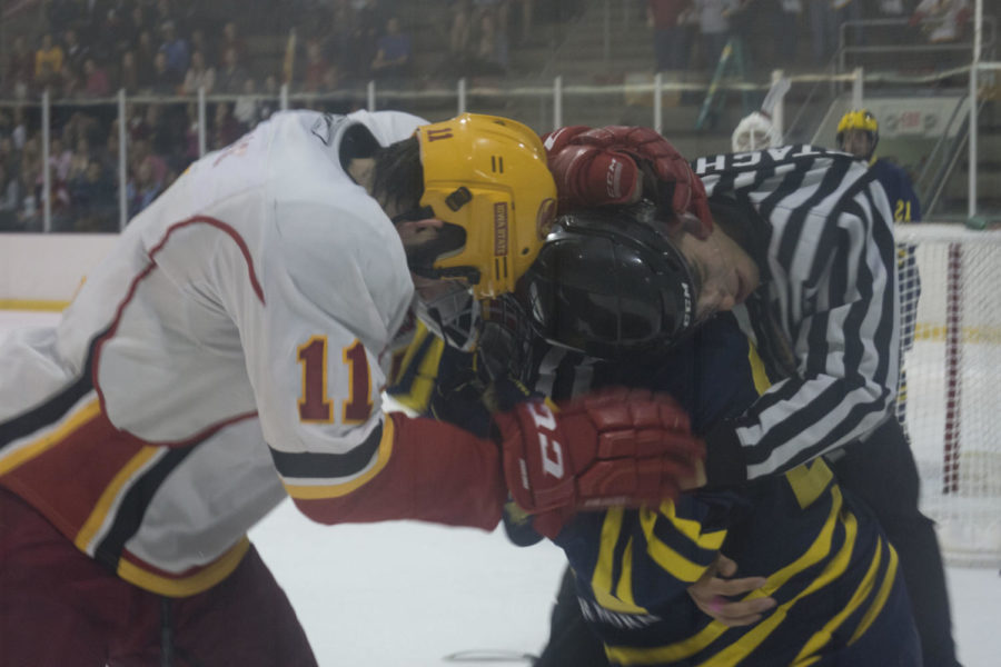 A referee tries to break up the fight between senior forward J.P. Kascsak and a Michigan-Dearborn player. The Wolverine exited the game after the fight was broken up, and Kascask had a two-penalty sit out in the penalty box. The Cyclones won the Oct. 24 game 4-2. 
