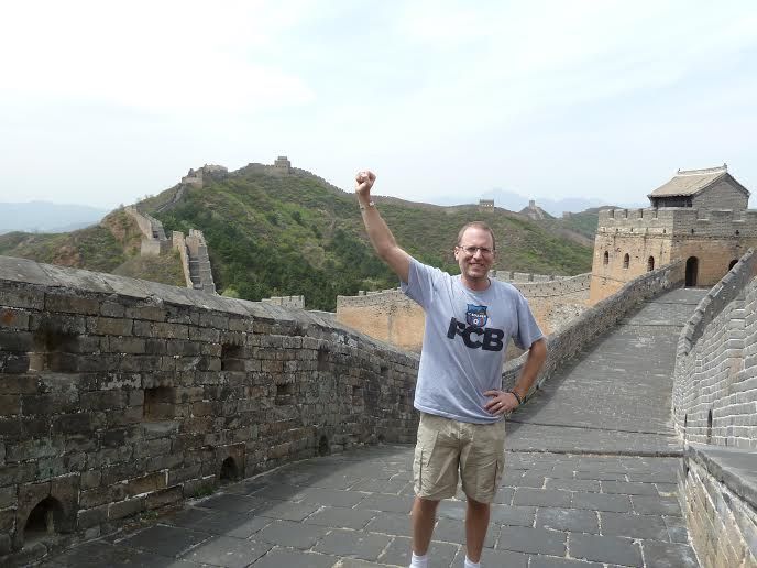 John Shors standing on the Great Wall of China.