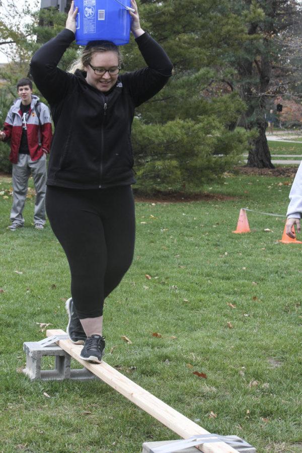 Allie Oberg, sophomore in elementary education, finishes the water-walk obstacle course outside of the library with a time of 1:19. Engineers Without Boundaries designed the course for Poverty Awareness Week to show the struggles of getting water for people in Ghana.
