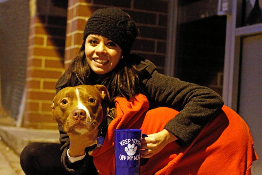 Paige Whiting, senior in communication studies, sits outside on Nov. 11 at AJs Ultra Lounge with one of the dogs from the Story County Animal Shelter. Whiting is raising money by selling mugs for the animal shelter through the event Mugs 4 Pugs.