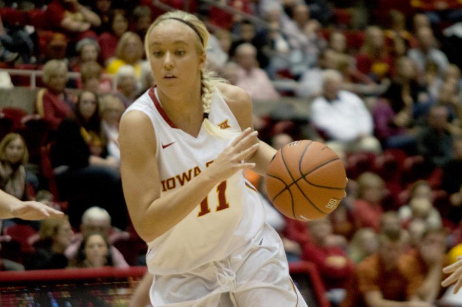 Sophomore Jadda Buckley controls the ball while moving down court against Winona State. The game took place Nov. 9 at Hilton Coliseum and ended with an ISU win and a score of 64-29.