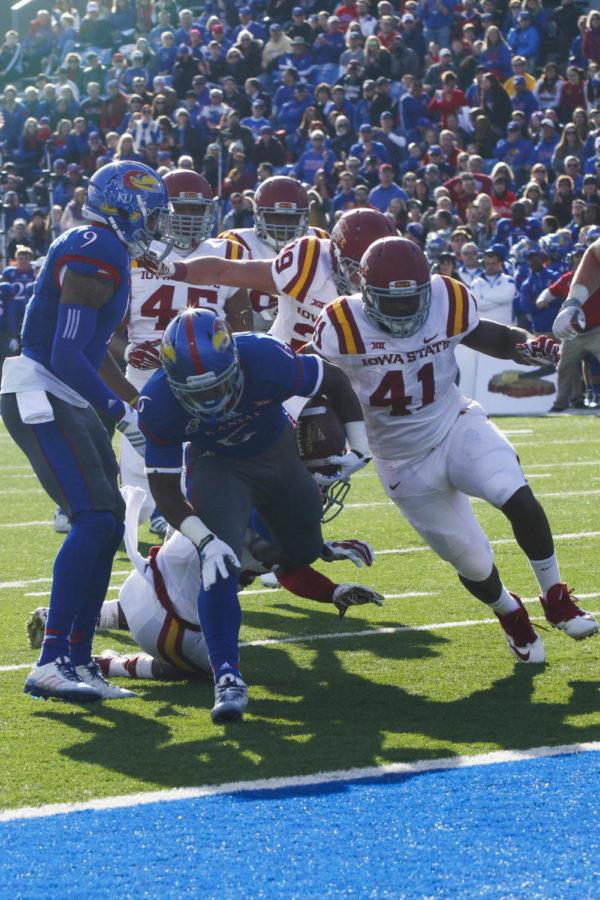 Members of the Cyclone defense attempt to take down running back Corey Avery on Nov. 8 at Lawrence, Kan. The Cyclones fell to the Jayhawks 34-14.