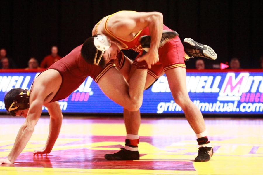 Michael Moreno tries to gain the upper hand over his opponent during his match in the 165 weight class. Moreno won by decision with a score of 7-3. Iowa State was unsuccessful in pulling ahead of Minnesota and fell with a final of 27-12. 