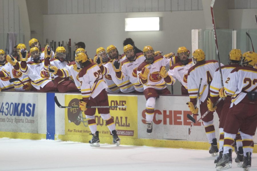 The Cyclone Hockey bench fist pumps to the starting lineup after they score a goal in the third period during their matchup on Nov. 22. ISU defeated Colorado State with a final score of 5-2. 