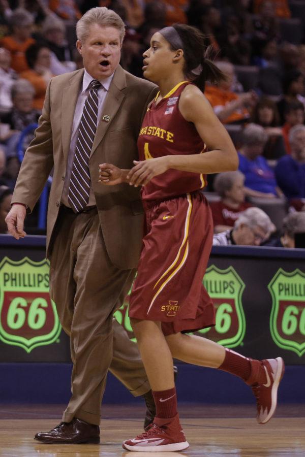 ISU womens basketball coach Bill Fennelly talks to Nikki Moody as she jogs toward the bench during Iowa States 67-57 loss to Oklahoma State on March 8, 2014 at the Chesapeake Energy Arena in Oklahoma City, Okla. Moody is suing Fennelly and Iowa State for what she says was racial discrimination. 