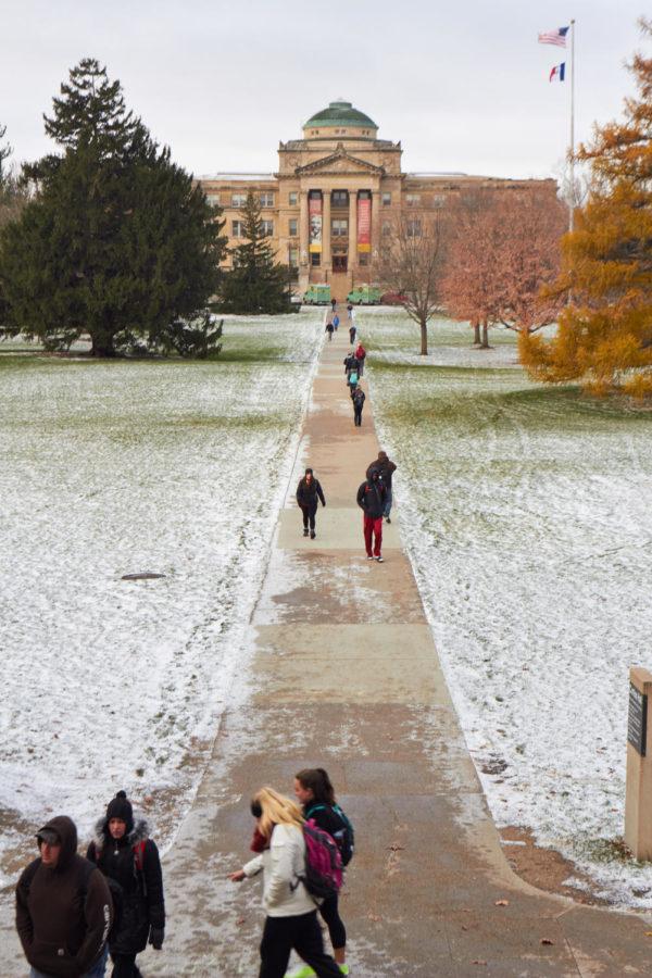 Students make the walk from Curtiss to Beardshear, braving the winds that sweep across Central Campus. The cold snap that hit ISU on Nov. 11 brought the first snow of the winter and has caused many students to turn to CyRide for transportation.
